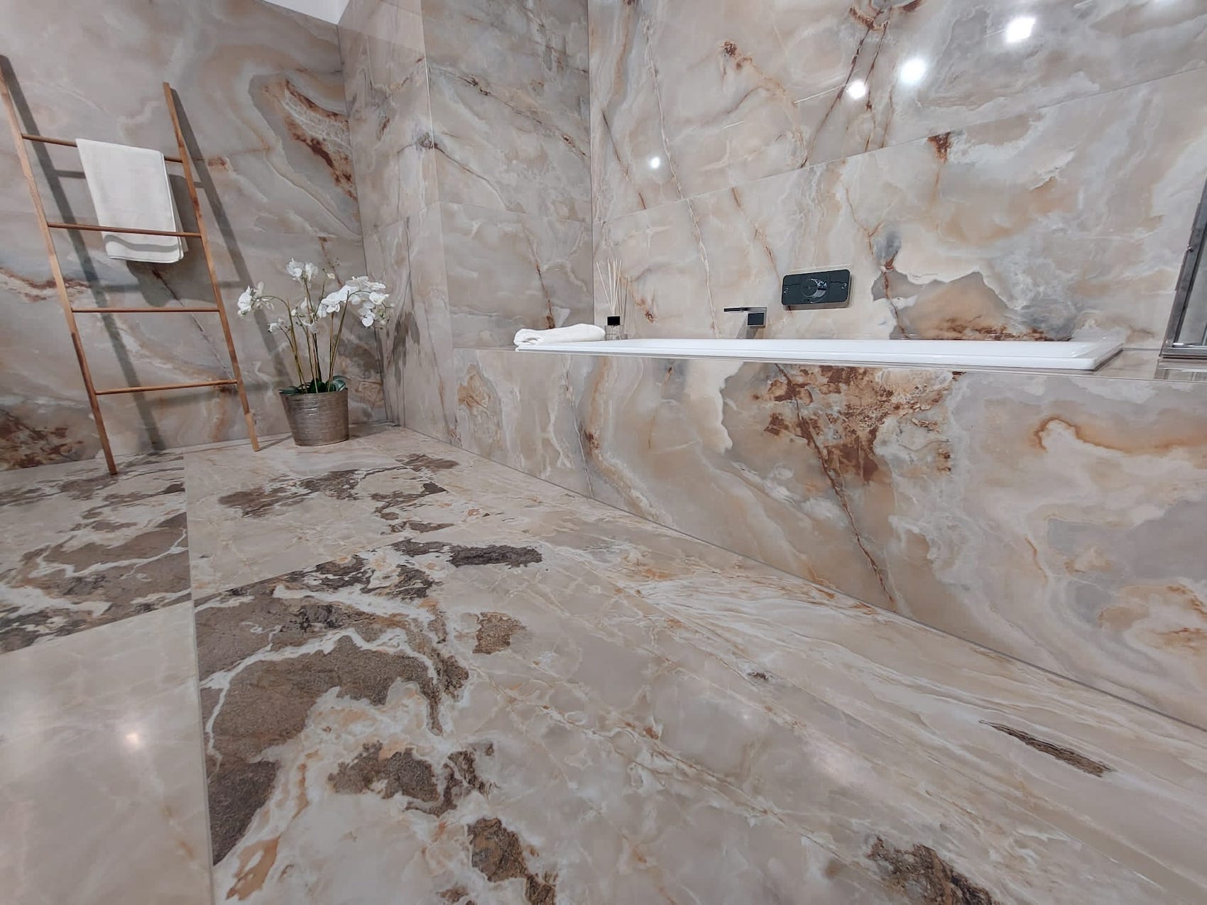 Koupelnová kóje z keramické dlažby Onyx and More v designu Golden Onyx a Golden Blend